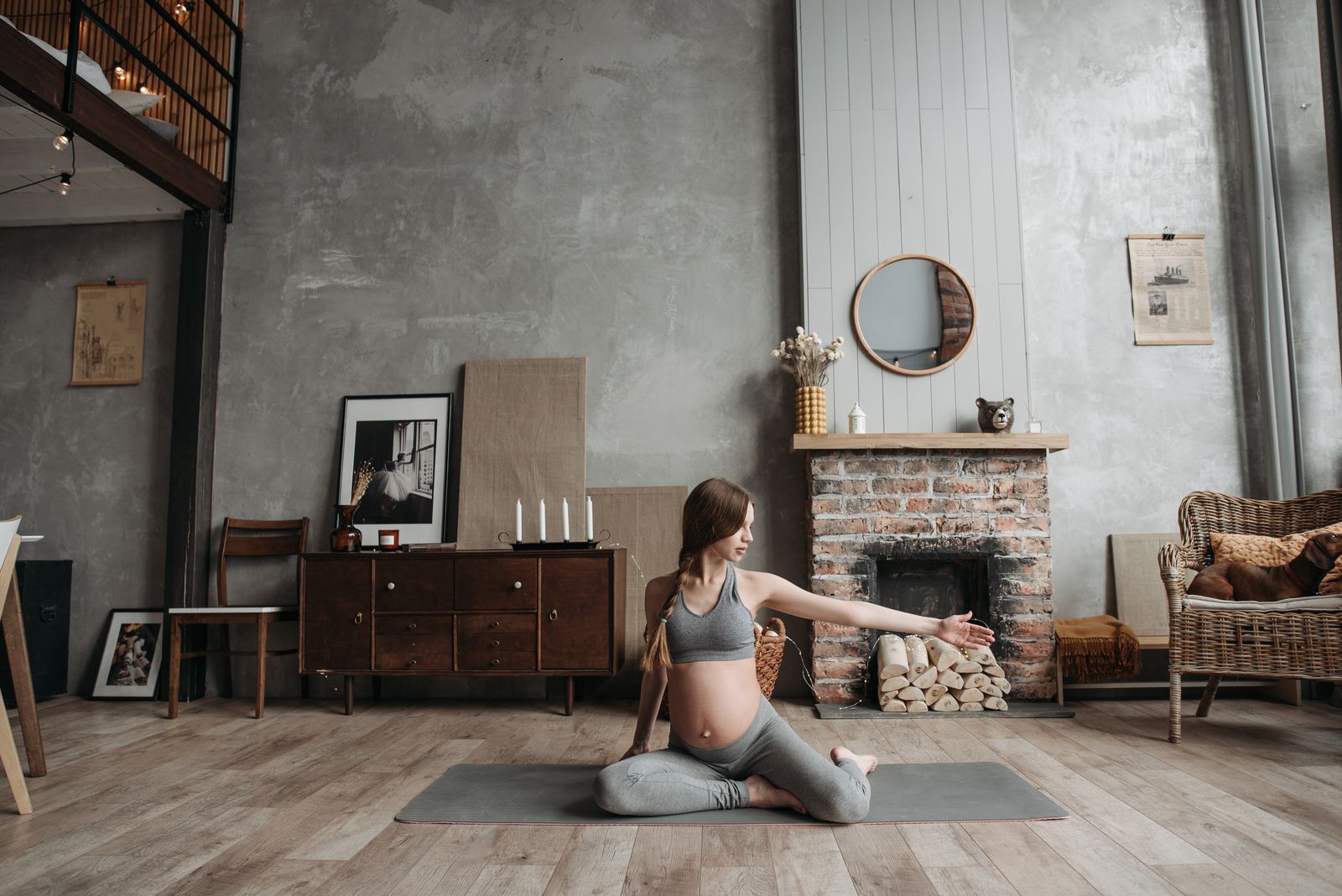 Pregnant person practicing gentle movement at home