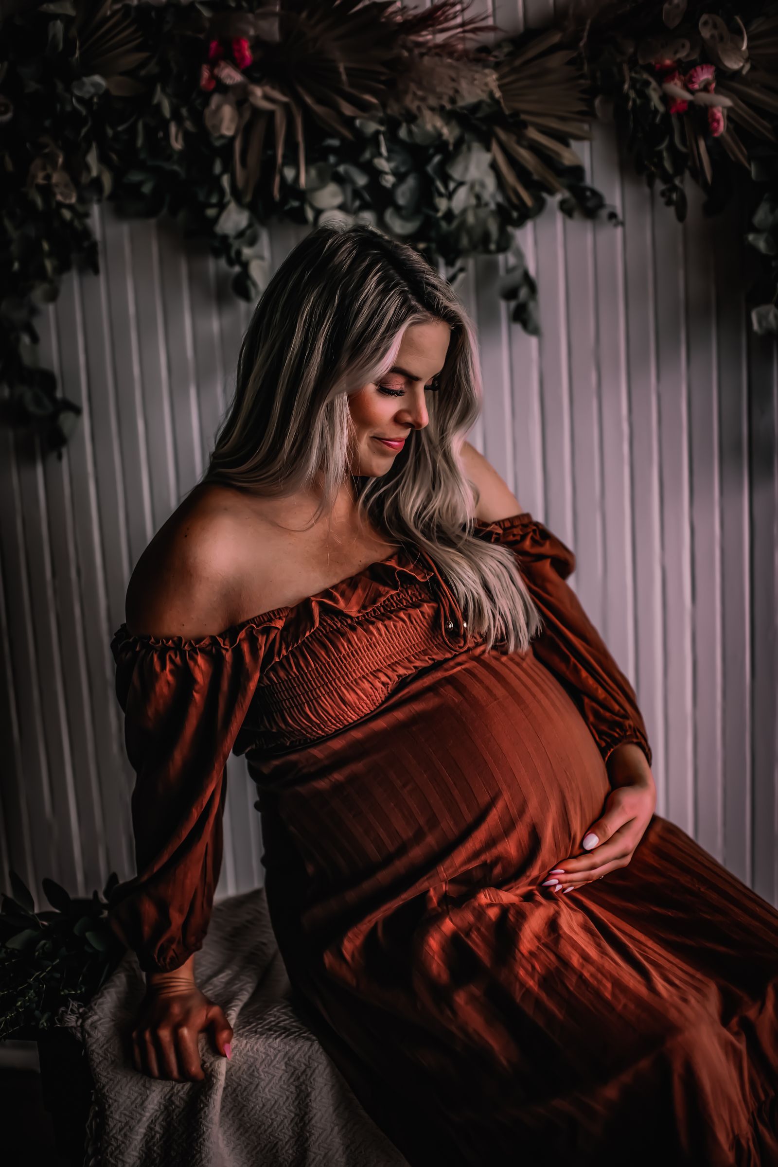 Pregnant person in a simple maternity dress