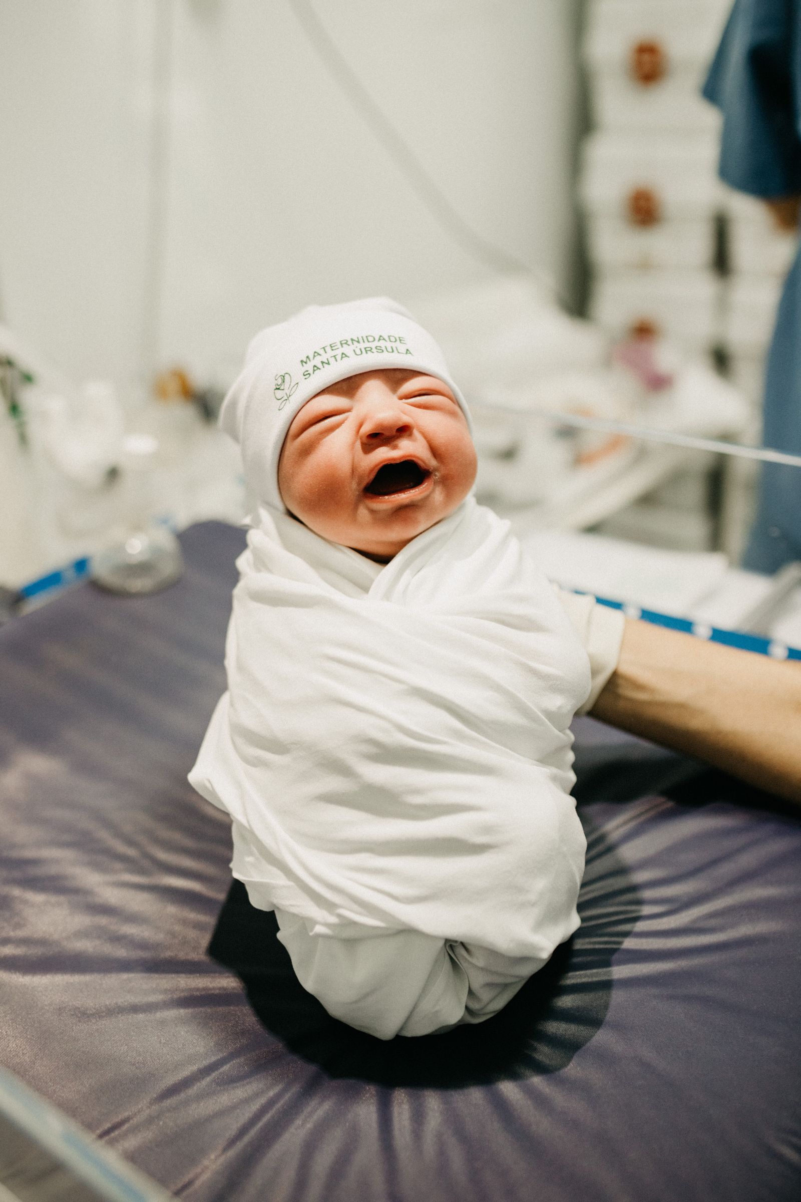 Newborn wrapped in a white blanket